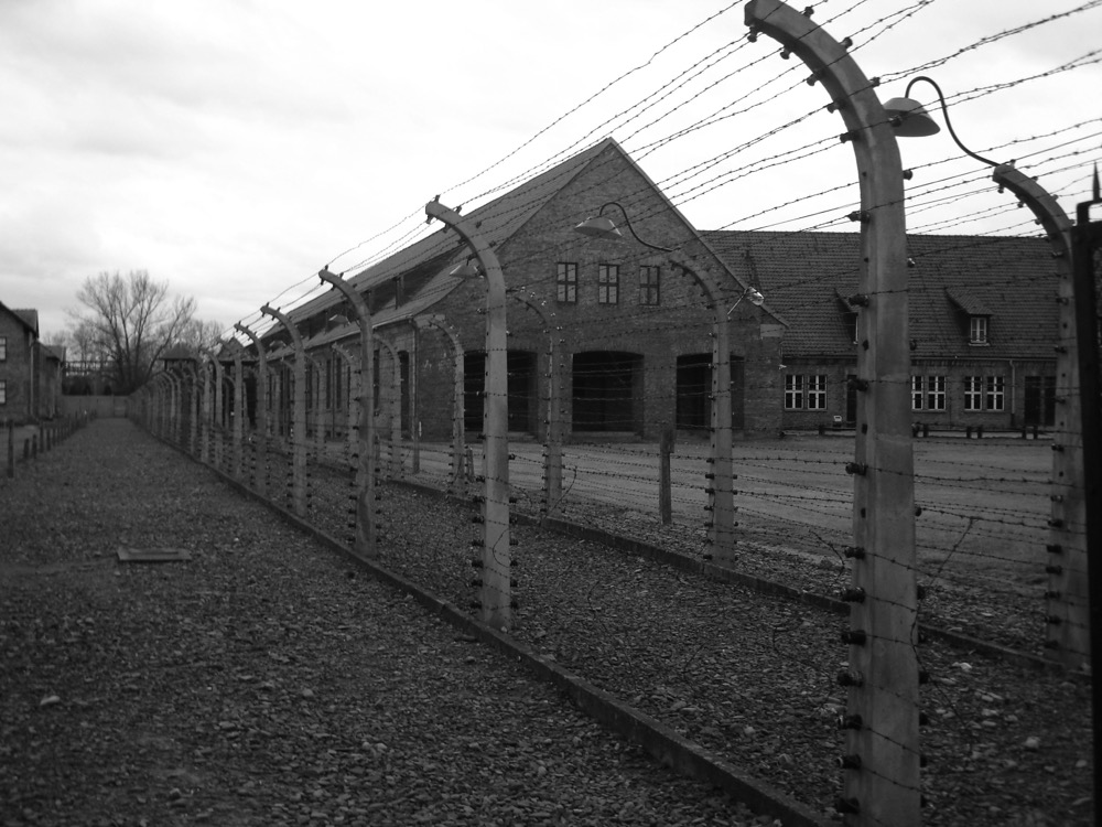 KL Auschwitz I: View as entering camp across electric fence.